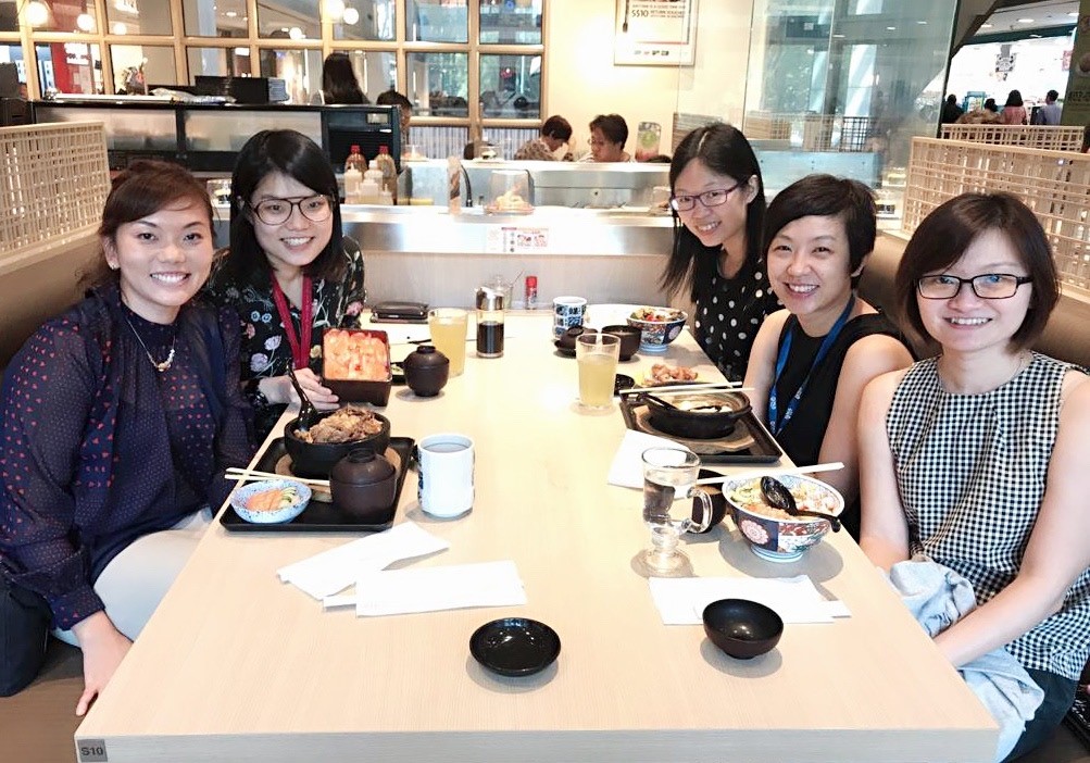 A group of women sitting at a table with foodDescription automatically generated with medium confidence